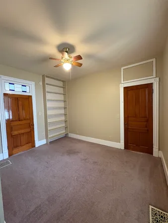 a view of empty room with a ceiling fan