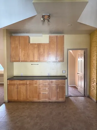 a kitchen with granite countertop white cabinets and sink