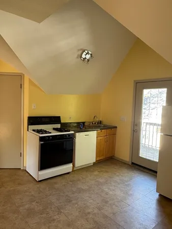 a view of a kitchen with dishwasher and a stove
