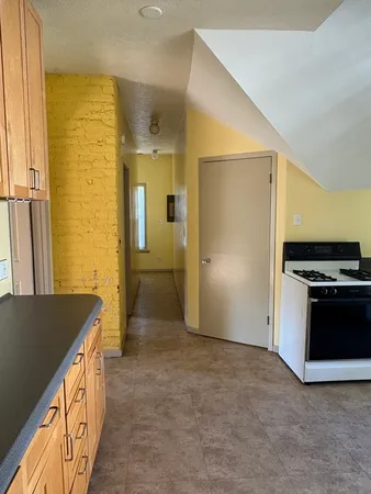 an empty room with a window and ceiling fan