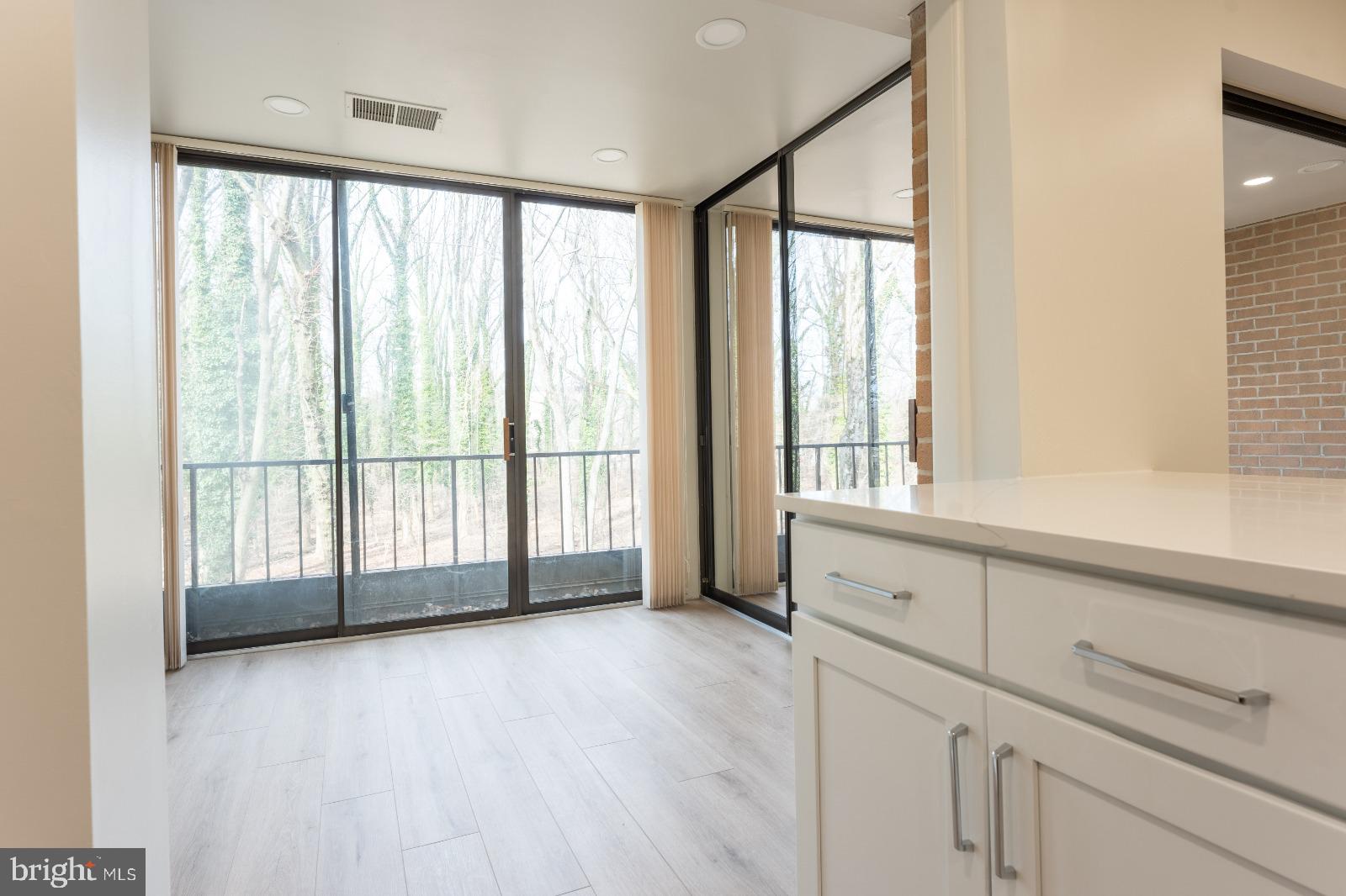 6350 Red Cedar Place, Unit 309 Baltimore, MD 21209 - Photo 11 of 29 a view of an empty room with wooden floor and a window