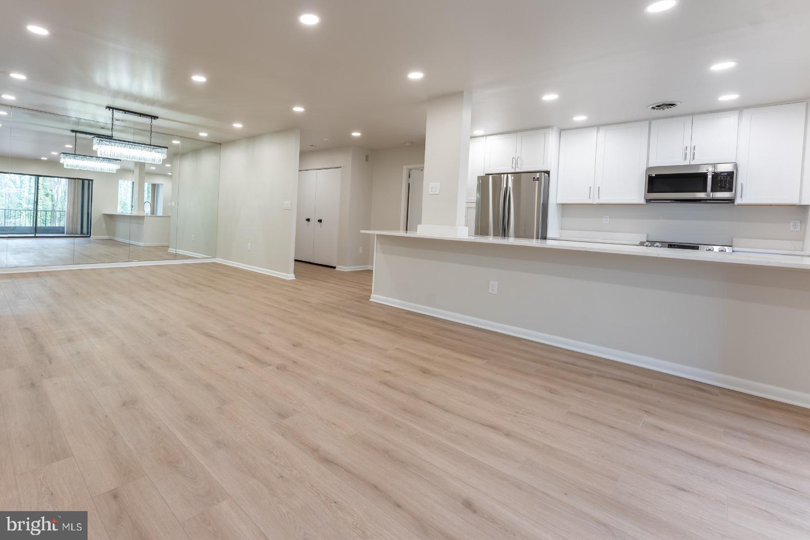 6350 Red Cedar Place, Unit 309 Baltimore, MD 21209 - Photo 14 of 29 a view of kitchen with kitchen island stainless steel appliances wooden cabinets and window
