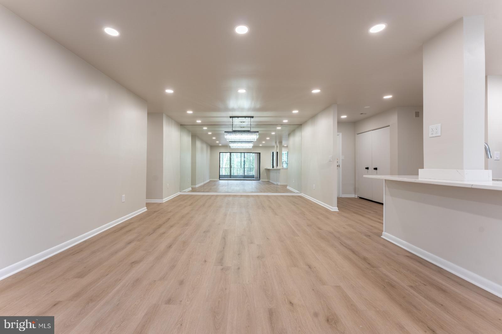 6350 Red Cedar Place, Unit 309 Baltimore, MD 21209 - Photo 16 of 29 a view of empty room with wooden floor