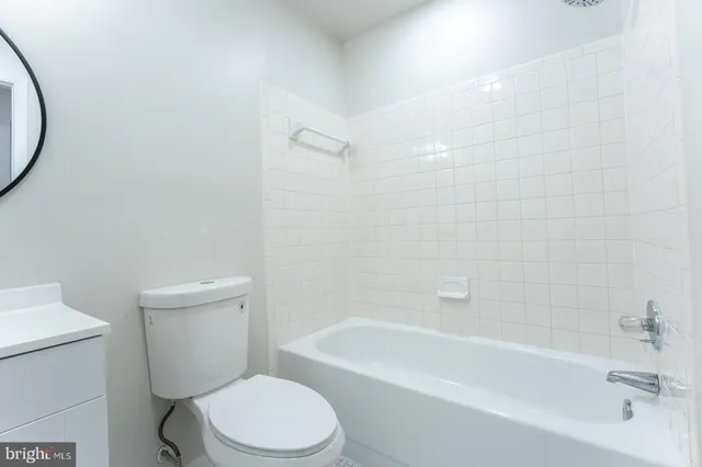 a bathroom with a toilet and a bathtub