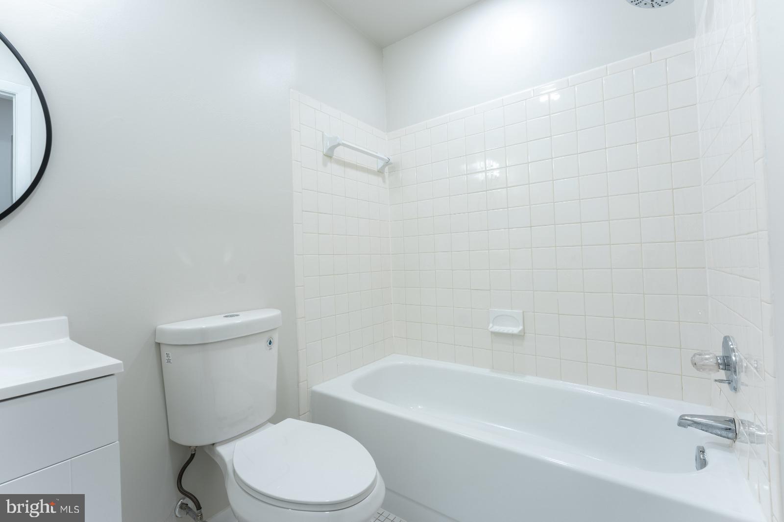 6350 Red Cedar Place, Unit 309 Baltimore, MD 21209 - Photo 26 of 29 a bathroom with a toilet and a bathtub