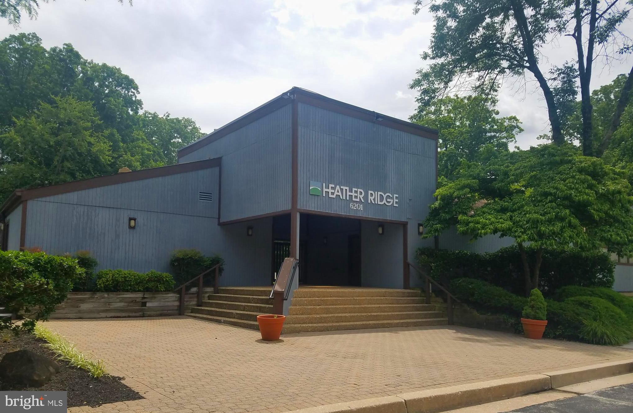 6350 Red Cedar Place, Unit 309 Baltimore, MD 21209 - Photo 5 of 29 a view of a house with a yard and plants