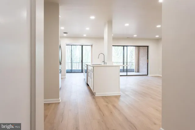 a view of a kitchen with wooden floor and electronic appliances