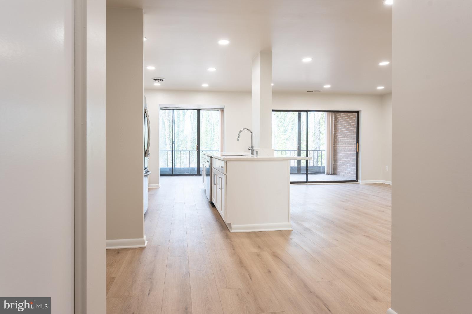 6350 Red Cedar Place, Unit 309 Baltimore, MD 21209 - Photo 7 of 29 a view of a kitchen with wooden floor and electronic appliances