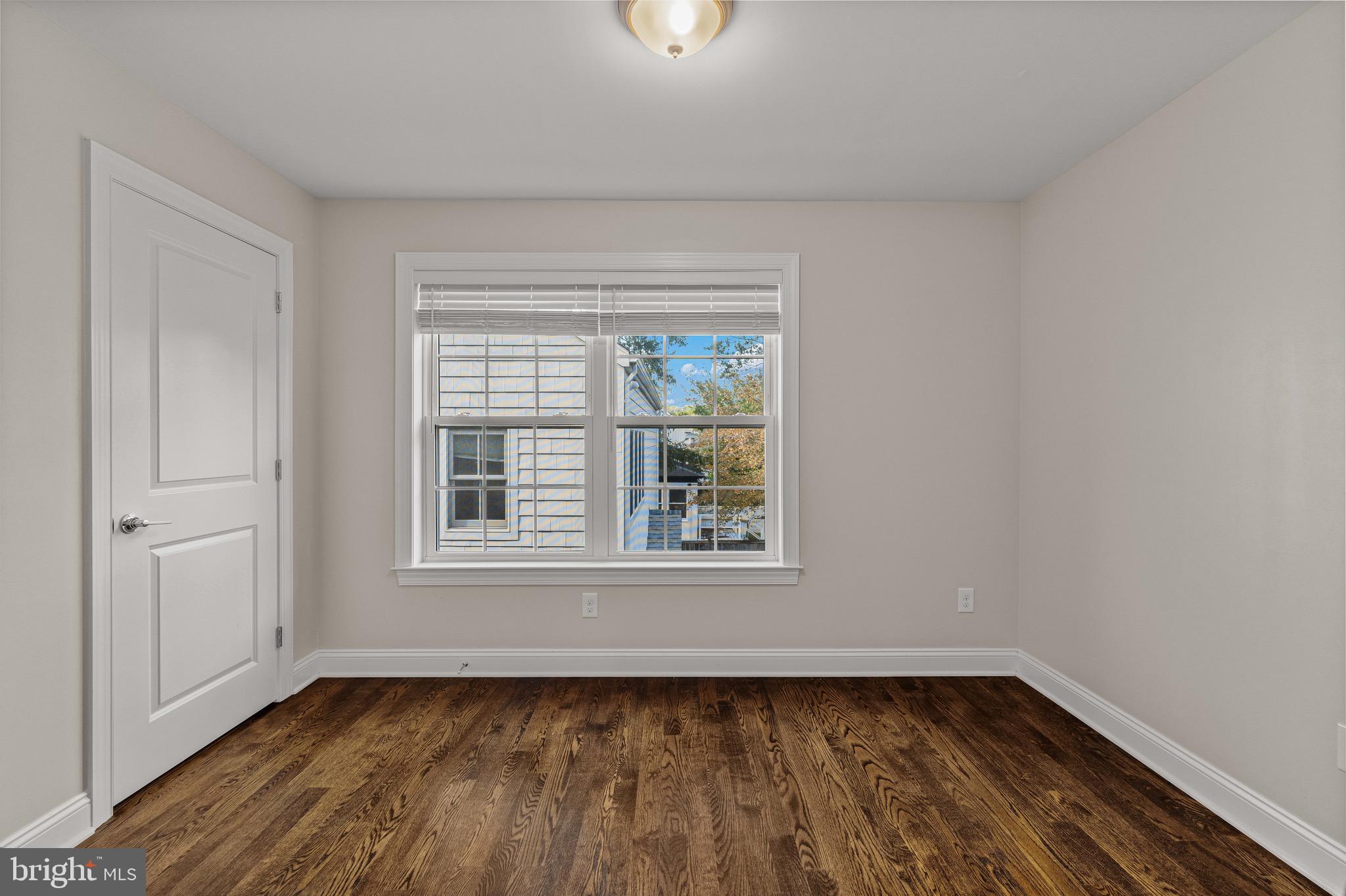 303 # 2 Witherspoon Street Princeton, NJ 08542 - Photo 12 of 31 a view of an empty room with wooden floor and a window