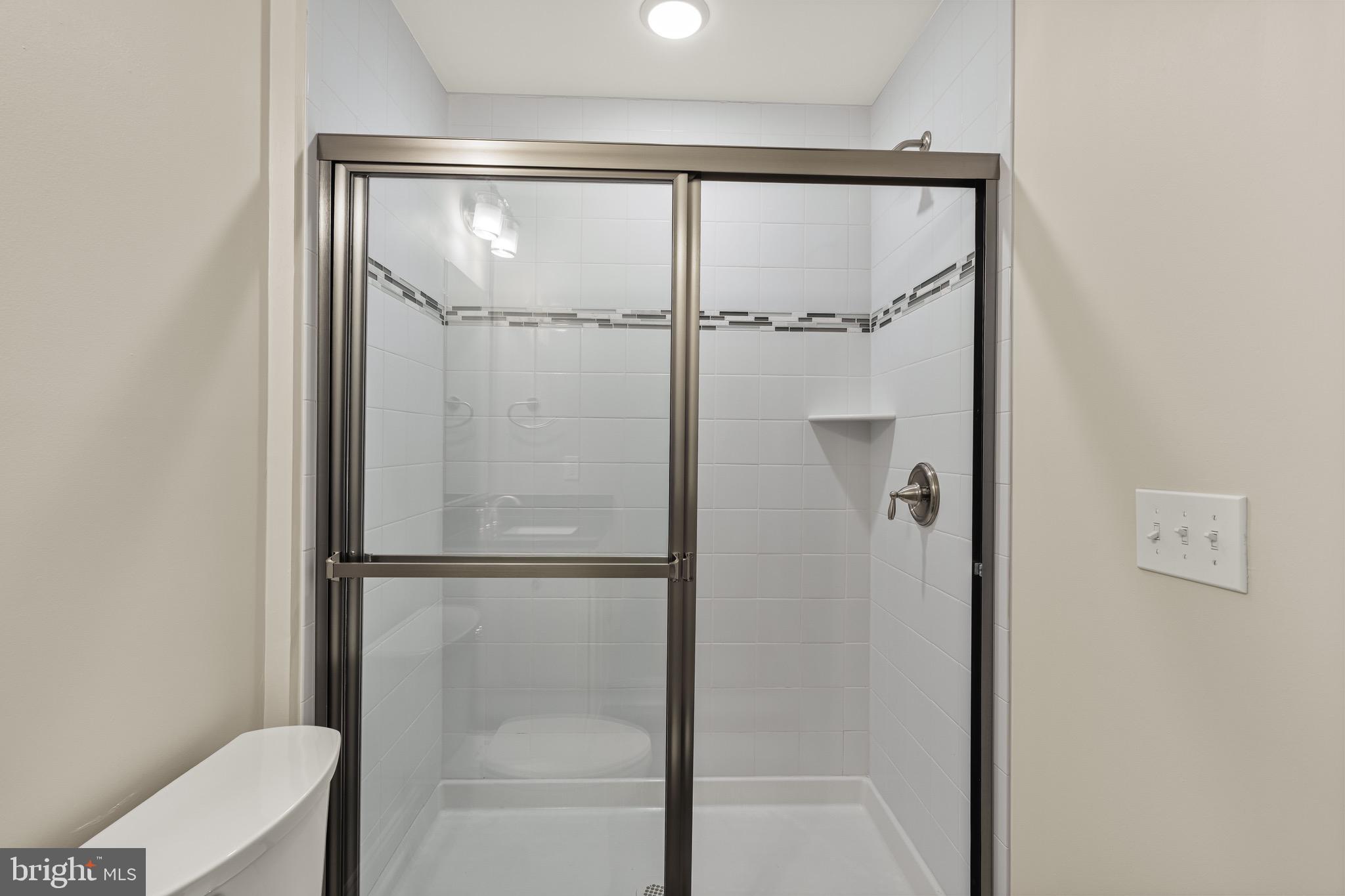 303 # 2 Witherspoon Street Princeton, NJ 08542 - Photo 14 of 31 a bathroom with a glass shower door