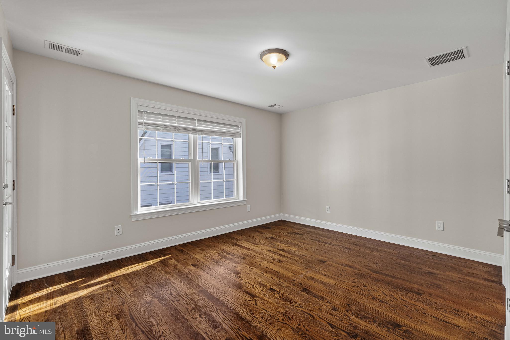 303 # 2 Witherspoon Street Princeton, NJ 08542 - Photo 21 of 31 a view of an empty room with wooden floor and a window