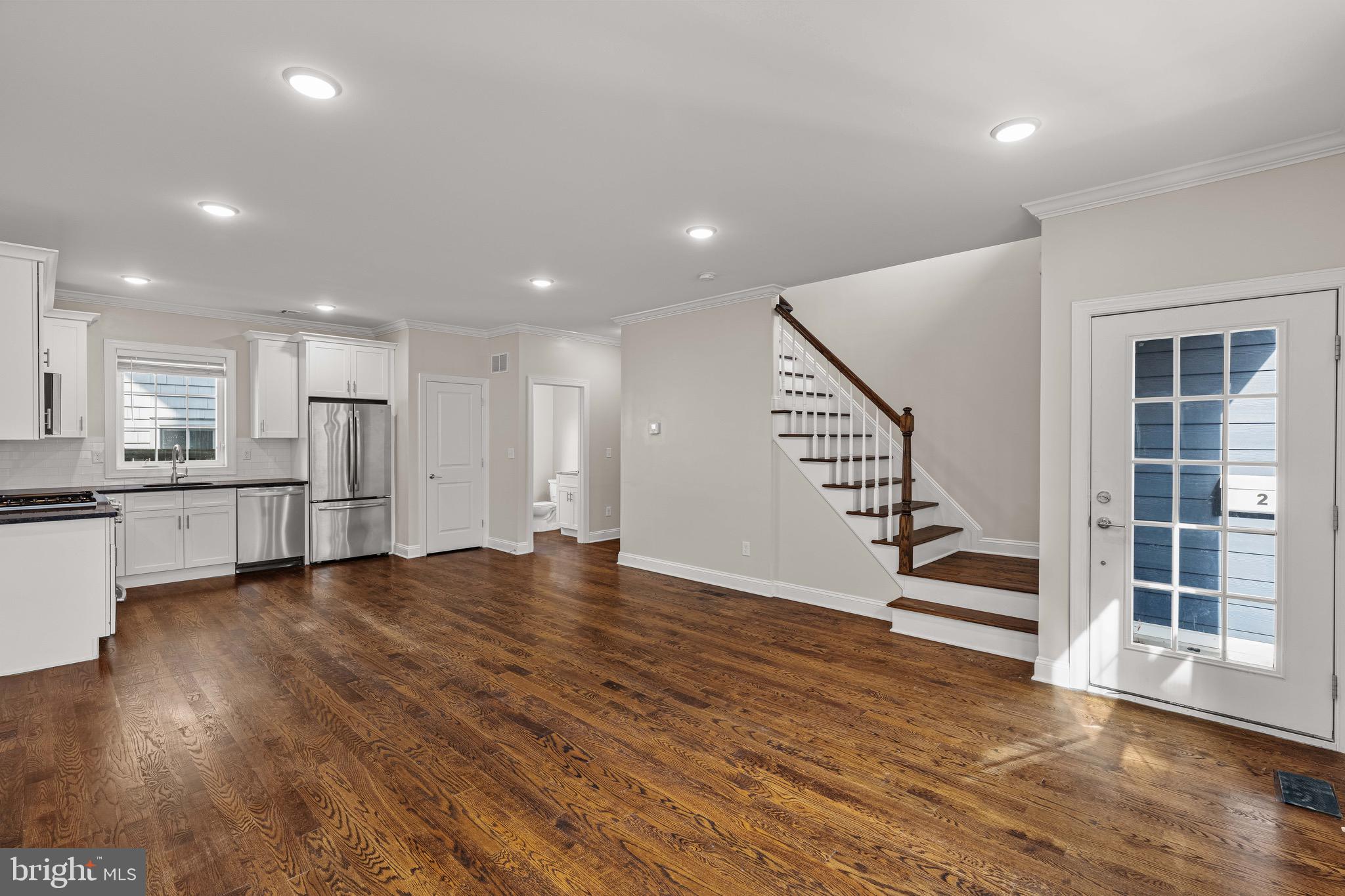 303 # 2 Witherspoon Street Princeton, NJ 08542 - Photo 8 of 31 a view of an empty room with wooden floor and a kitchen