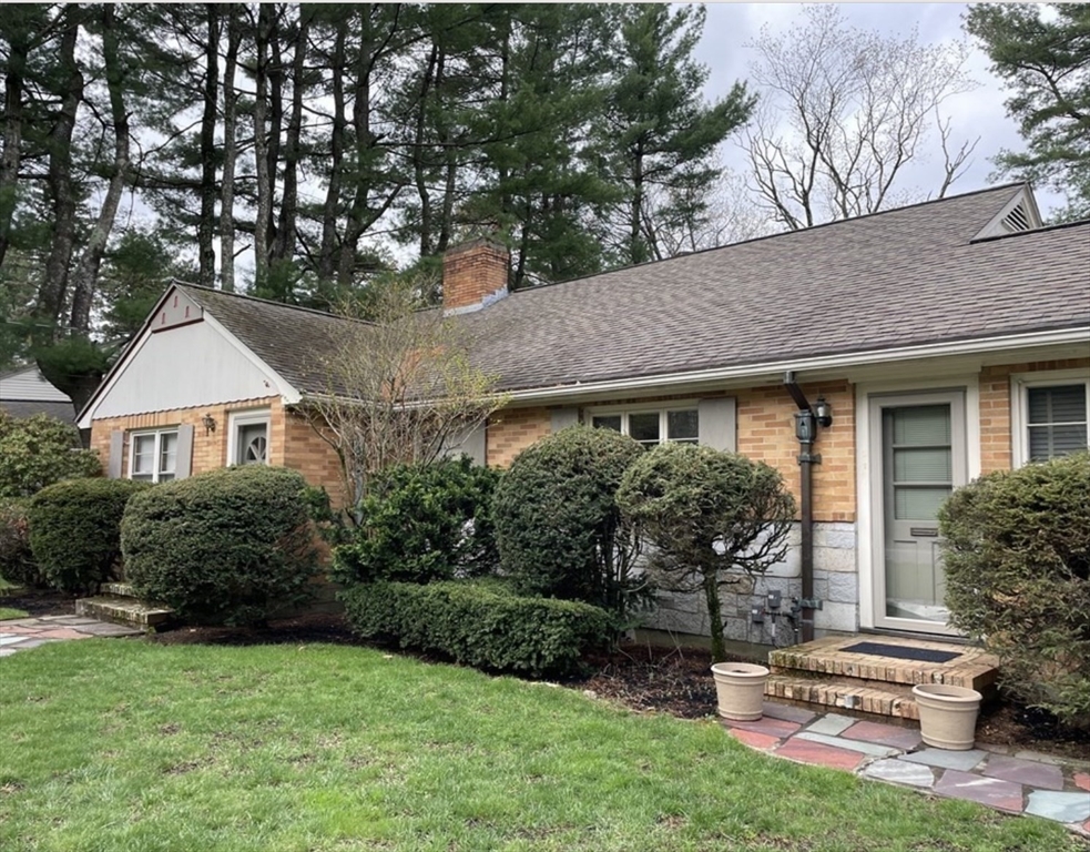 a front view of house with yard and green space