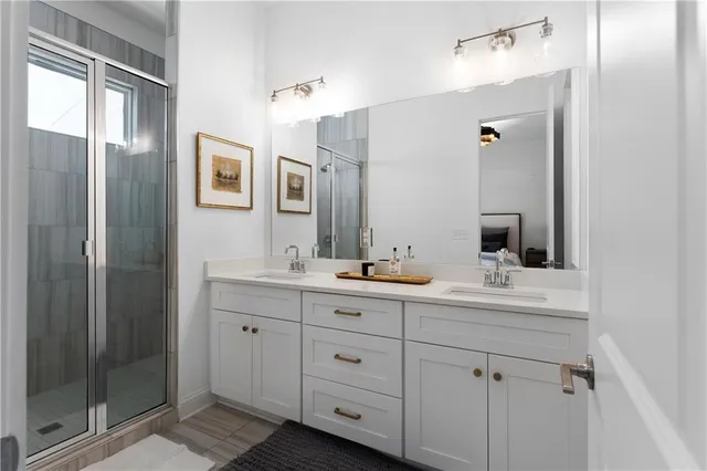 a bathroom with a double vanity sink and mirror