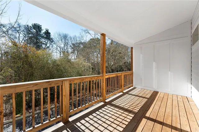 a view of balcony with wooden floor and fence