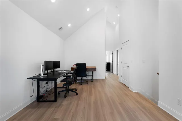 a view of a workspace with furniture and wooden floor