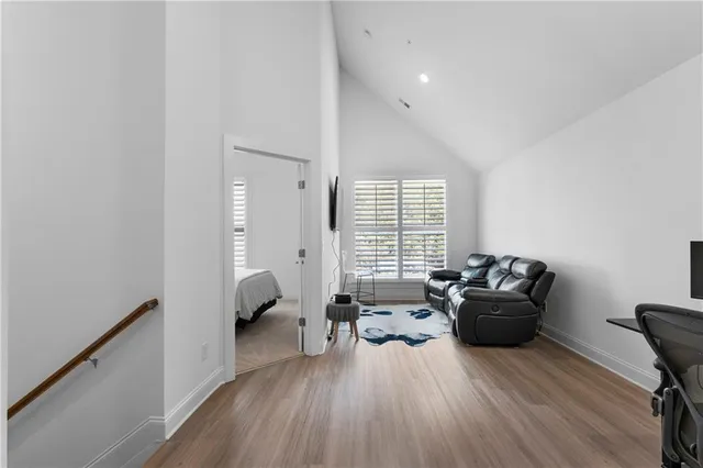 a living room with furniture and a wooden floor