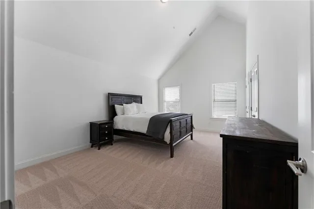 a bedroom with a bed and a table