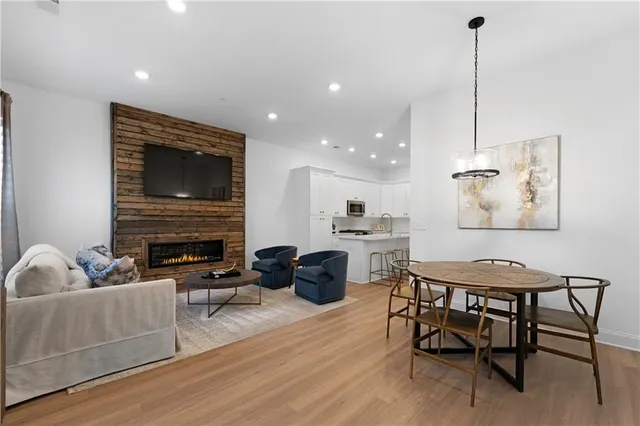 a living room with furniture a fireplace and a flat screen tv