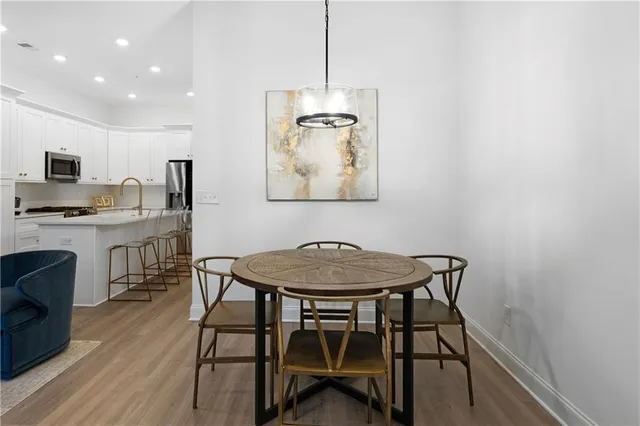 a view of a dining room with furniture and wooden floor