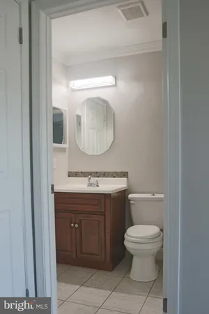 a bathroom with a toilet a sink and mirror