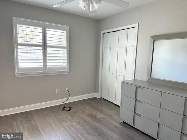 a view of a livingroom with wooden floor and window