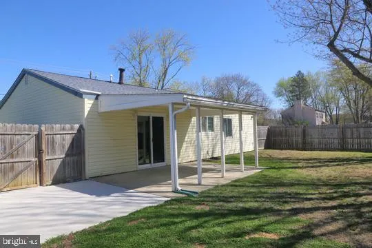 a view of a house with a yard and pathway