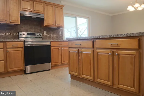 a kitchen with stainless steel appliances granite countertop a refrigerator and sink