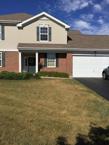 a front view of a house with garage