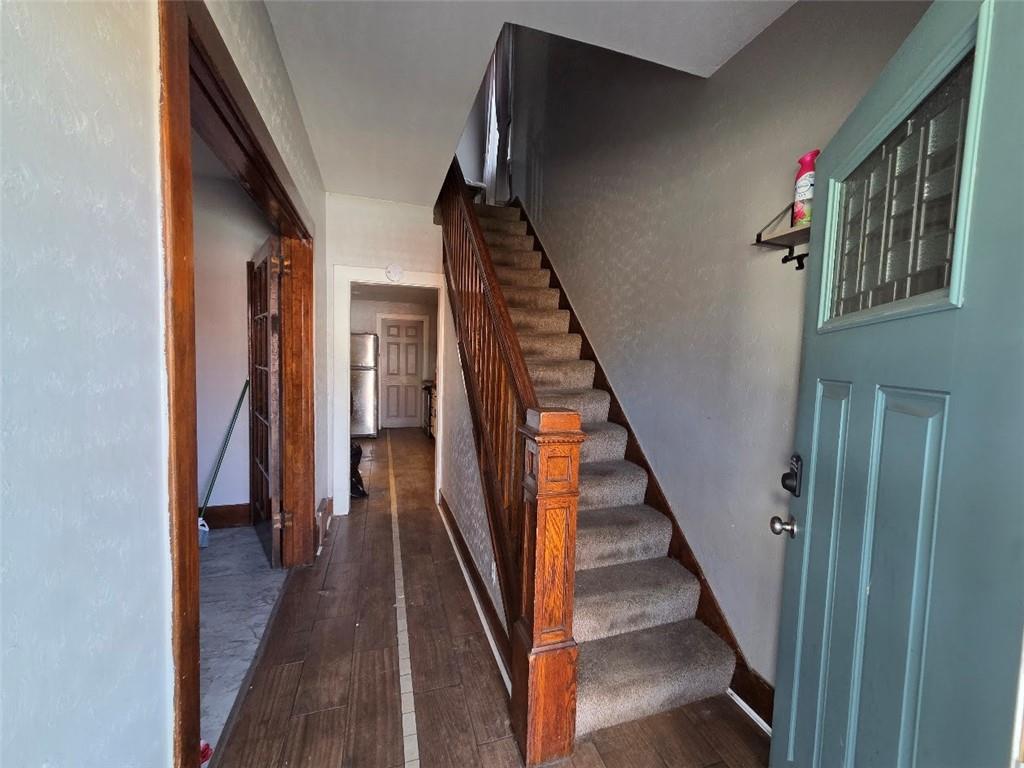 735 South 14th Street Monessen, PA 15062 - Photo 4 of 15 a view of a hallway with wooden floor and stairs