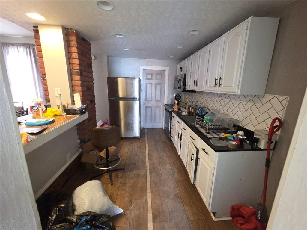 735 South 14th Street Monessen, PA 15062 - Photo 7 of 15 a kitchen with a sink stove and refrigerator