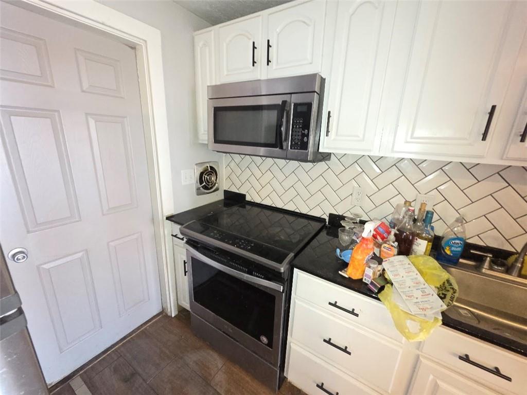 735 South 14th Street Monessen, PA 15062 - Photo 8 of 15 a kitchen with stainless steel appliances white cabinets and a stove
