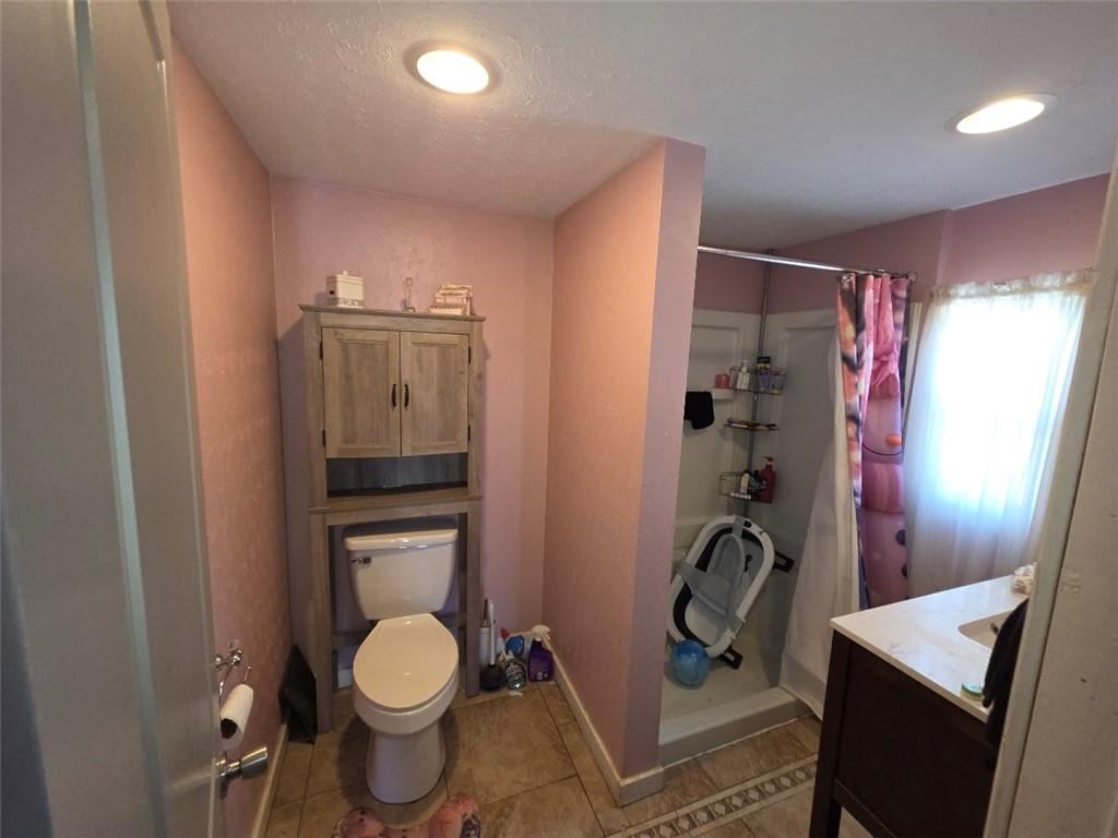 735 South 14th Street Monessen, PA 15062 - Photo 9 of 15 a bathroom with a toilet a sink and a shower