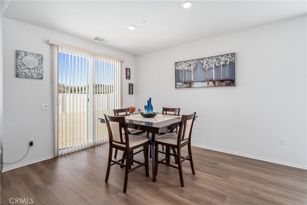 45628 Rachel Avenue Lancaster, CA 93535 - Photo 14 of 36 a view of a dining room with furniture window and wooden floor