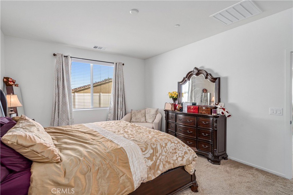 45628 Rachel Avenue Lancaster, CA 93535 - Photo 16 of 36 a bedroom with a bed and wooden floor