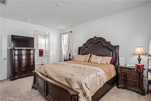 a bedroom with a bed and a television