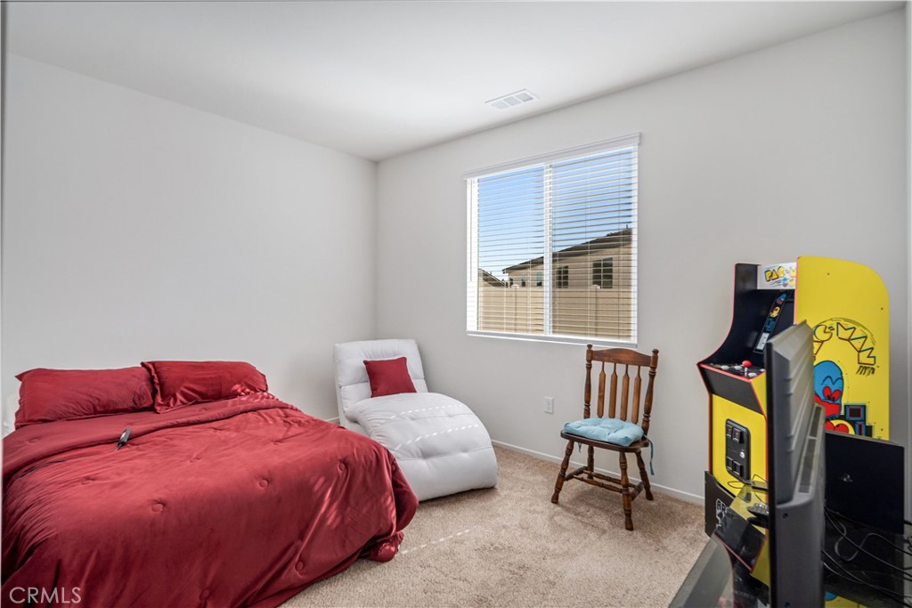 45628 Rachel Avenue Lancaster, CA 93535 - Photo 21 of 36 a bedroom with a bed and window