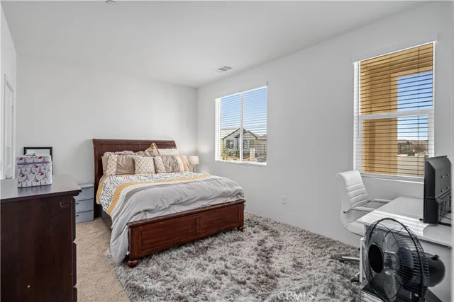 a bedroom with a bed next to a window