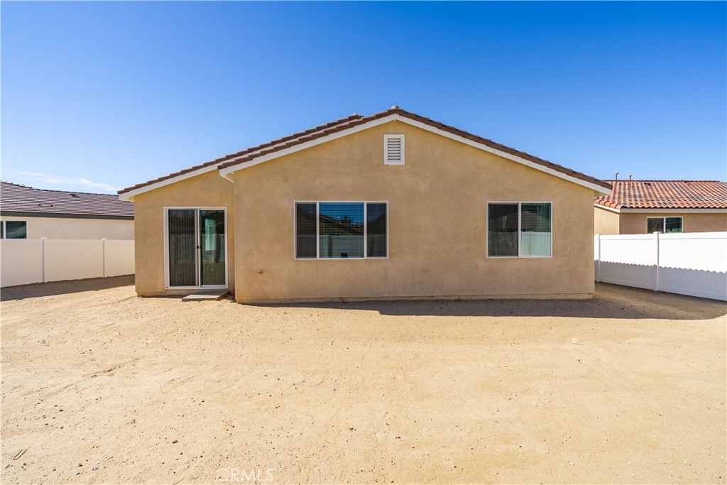 45628 Rachel Avenue Lancaster, CA 93535 - Photo 29 of 36 a view of empty house with yard and covered with snow in the background