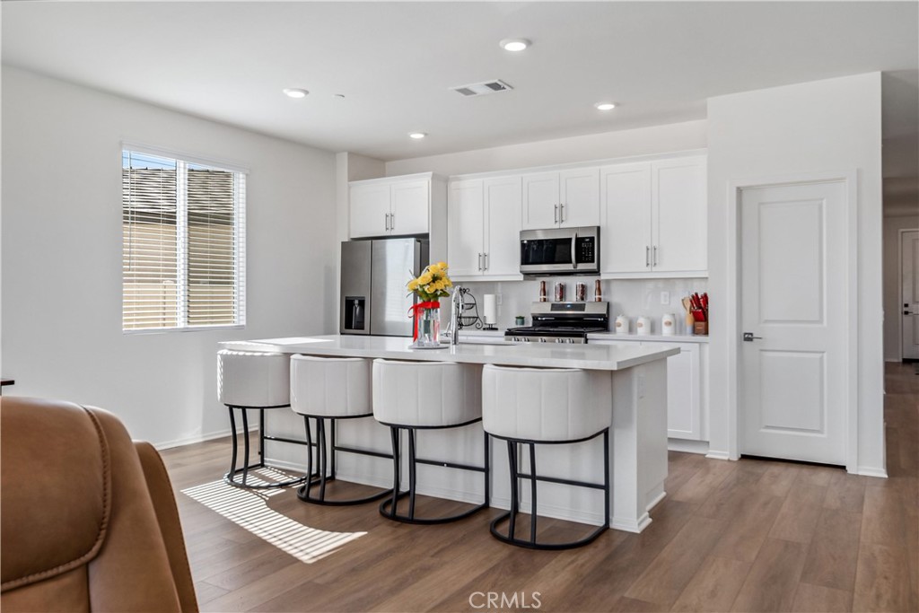 45628 Rachel Avenue Lancaster, CA 93535 - Photo 10 of 36 a kitchen with a sink cabinets and wooden floor