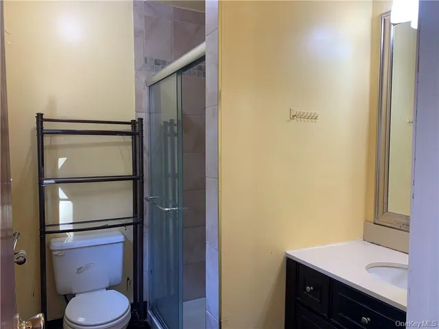 a bathroom with a toilet a sink and vanity