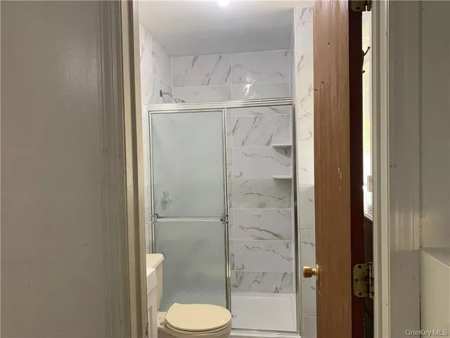 a bathroom with a granite countertop shower