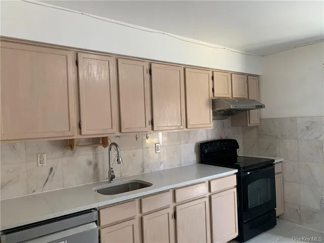 a kitchen with a sink cabinets and appliances