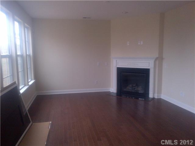 1711 Sutters Mill Way, Unit 232 Fort Mill, SC 29708 - Photo 3 of 4 a view of an empty room with wooden floor and a window