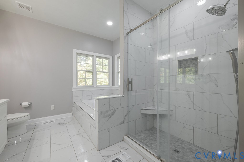 15438 West Patrick Henry Road Montpelier, VA 23192 - Photo 12 of 45 a bathroom with a granite countertop sink a toilet and a shower