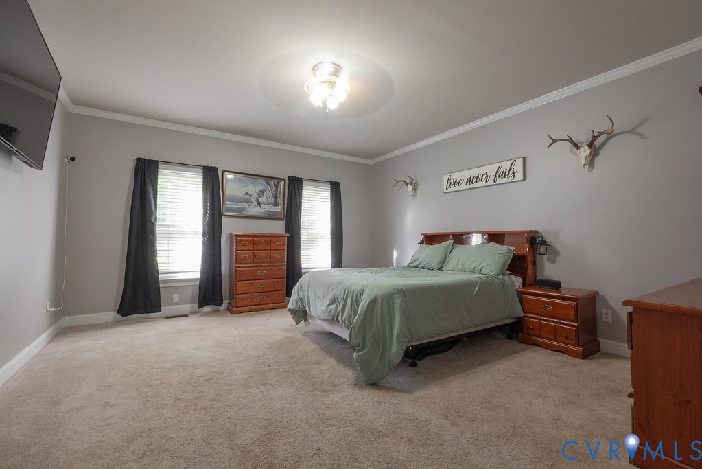 15438 West Patrick Henry Road Montpelier, VA 23192 - Photo 14 of 45 a spacious bedroom with a bed and a large window
