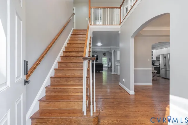 a view of entryway and hall with wooden floor