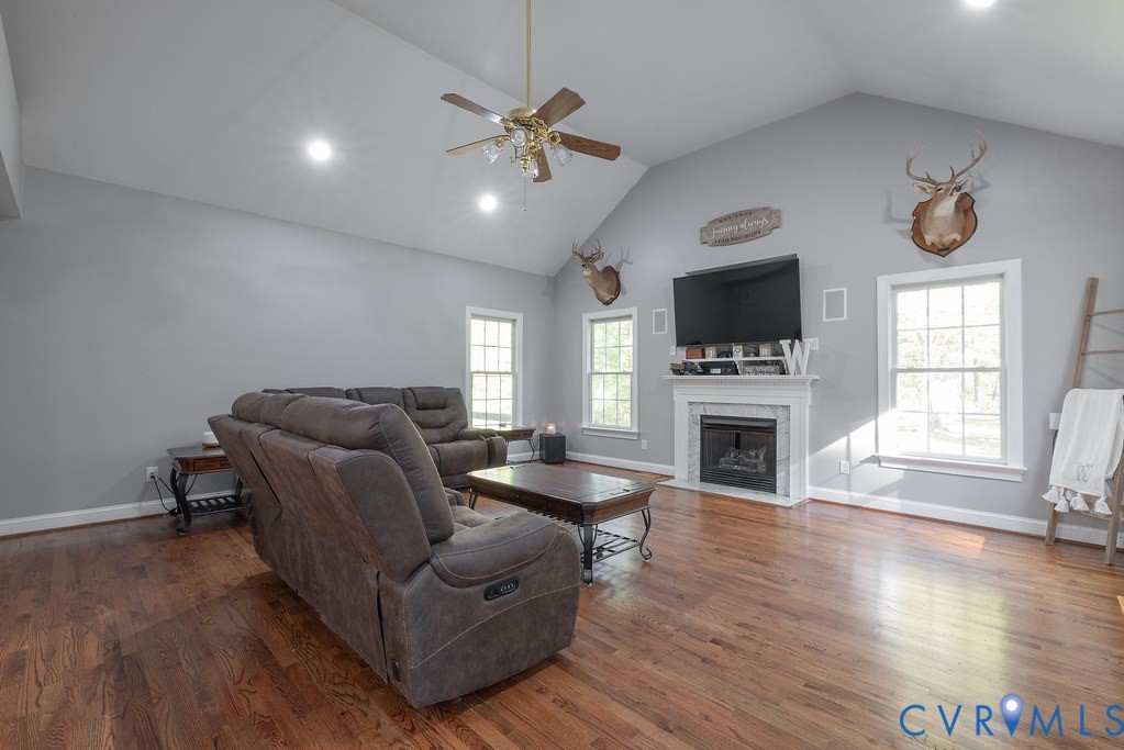 15438 West Patrick Henry Road Montpelier, VA 23192 - Photo 18 of 45 a living room with furniture a fireplace and a flat screen tv