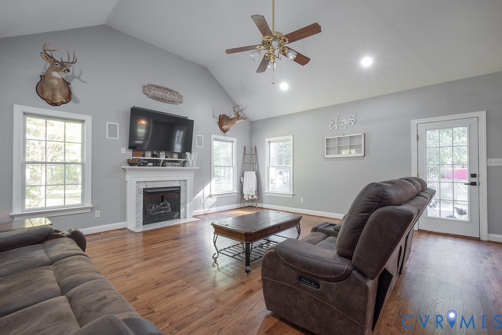 15438 West Patrick Henry Road Montpelier, VA 23192 - Photo 19 of 45 a living room with furniture a flat screen tv and a fireplace