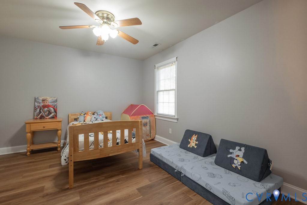 15438 West Patrick Henry Road Montpelier, VA 23192 - Photo 26 of 45 a bedroom with a bed and wooden floor